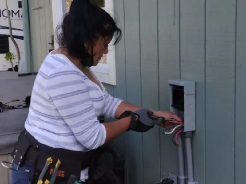 Licensed electrician wiring an exterior subpanel in Leander