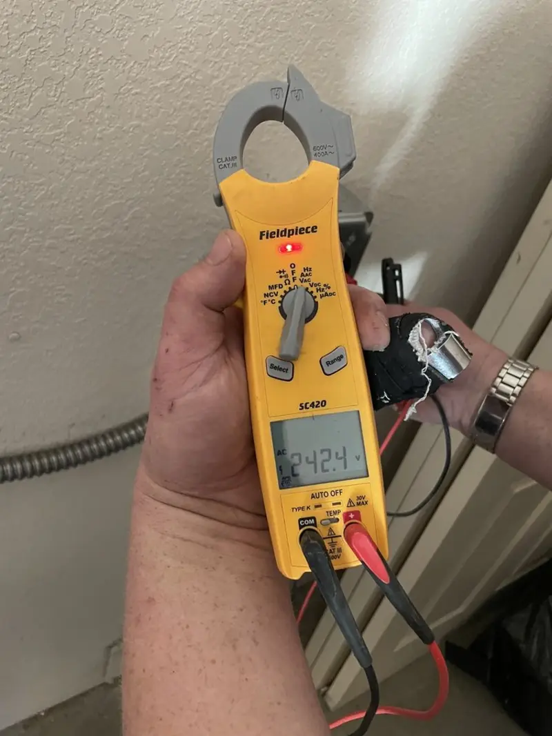 Voltage testing with clamp meter during Ceiling Fan Installation in Leander